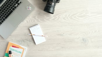 Desk with laptop and camera and notebook-1