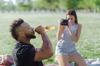 Drinking Jarritos soda in the park