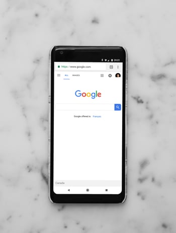 Google on iphone on a marble table-1