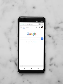 Google on iphone on a marble table-2