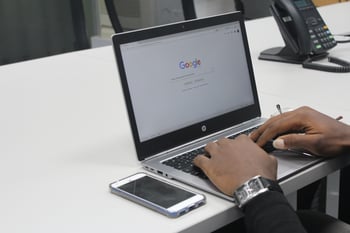 Hands on a laptop with google pulled up-1