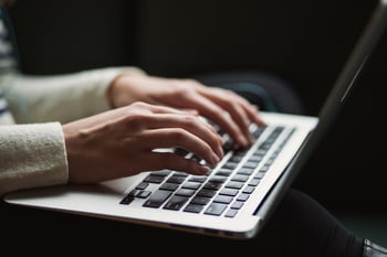 Hands typing on a keyboard