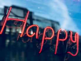 Neon sign with the word Happy | NOW Marketing Group: How to Create a Culture of Happiness