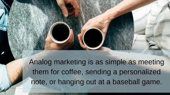 Overhead view of a coffee date with overlaid words, " Analog marketing is as simple as meeting them for coffee, sending a personalized message, or hanging out at a baseball game."