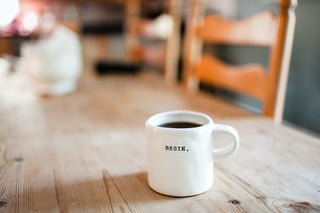 Mug on desk with the word Begin-1