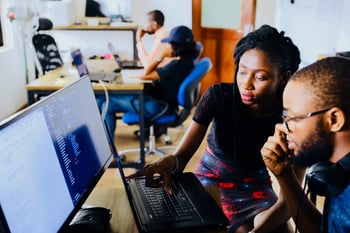 Two people looking at a computer together