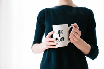 Woman holding mug that says like a boss