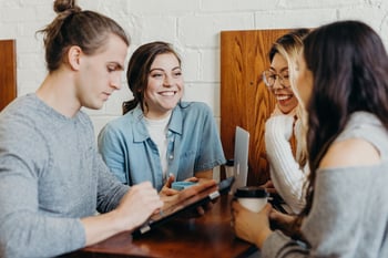 group of young adults with phones smiling-4