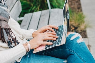 hands working on a laptop