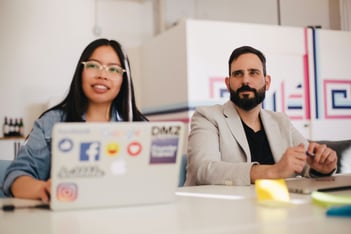 two people working at a desk-1