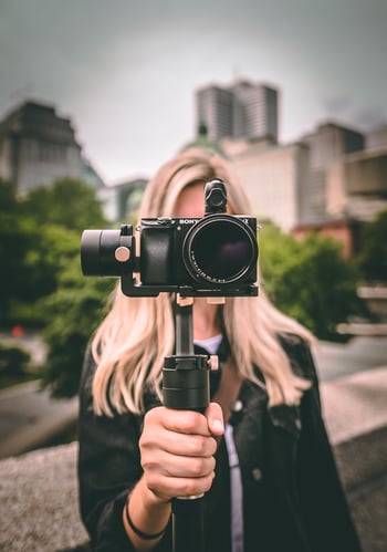 woman standing with camera facing towards us